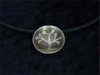 Etched and domed nickel silver pendant on black PVC cord